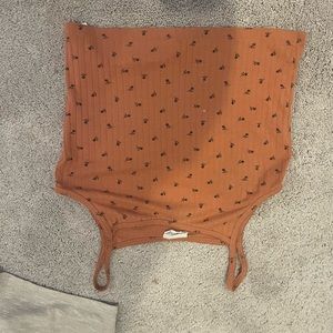 Orange pinkish tank top with small black flower detailing!